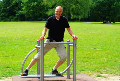 Portrait of senior man exercising at park
