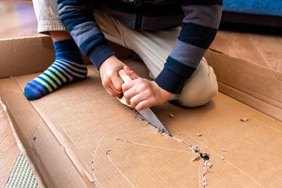 Low section of man sitting on table