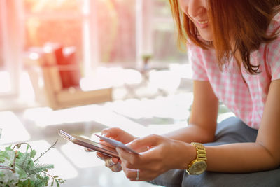 Midsection of woman using mobile phone