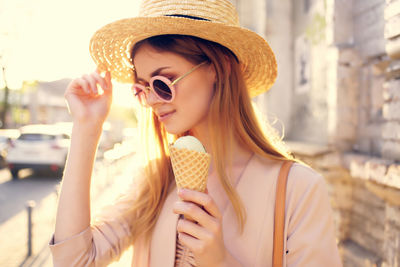 Portrait of young woman holding ice cream