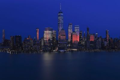 Illuminated buildings in city at waterfront