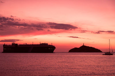 Silhouette ship on sea against sky during sunset