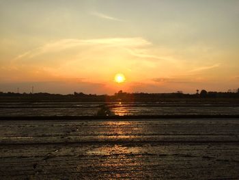 Scenic view of sunset over land