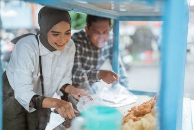 Portrait of young woman preparing food