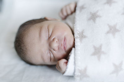 Sleeping baby lying in crib