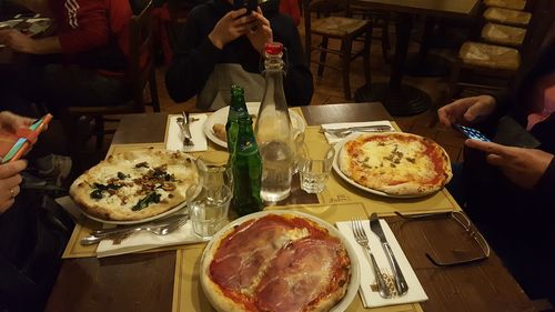 Midsection of woman holding food on table