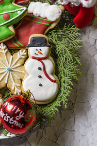 Directly above shot of gingerbread cookies and decorations on textured surface