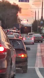 View of traffic on road at sunset