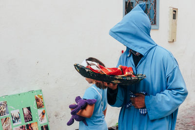 Rear view of people holding food