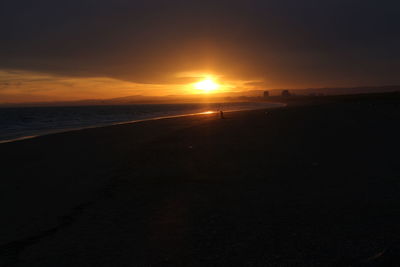 Scenic view of beach against sky during sunset