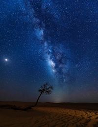 Scenic view of land against sky at night