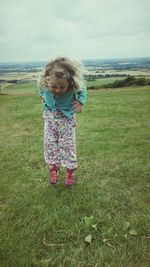 Girl standing on grassy field