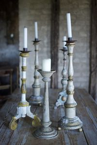 Close-up of old candlestick holders on wooden table