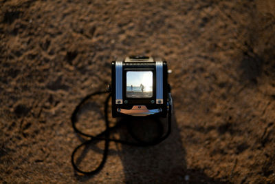 Close-up of vintage camera on rock