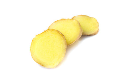 Close-up of yellow slices over white background