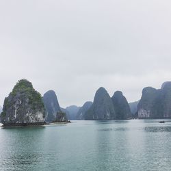 Scenic view of sea and mountains against sky