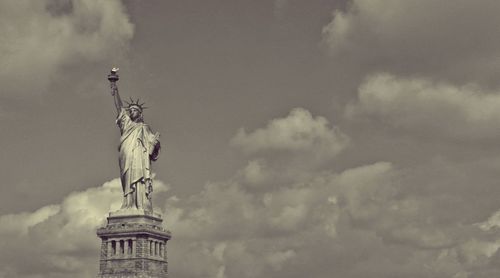 Low angle view of statue against cloudy sky