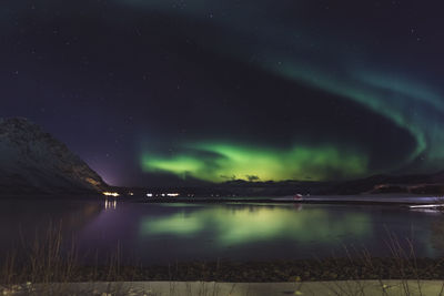 Scenic view of lake against sky at night