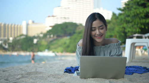 Young woman using mobile phone in park