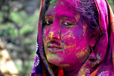 Woman covered with colors in the festival of holi in india