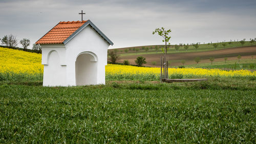 Scenic view of a chapel and fields in beautiful wavy countryside. clean environment and agriculture
