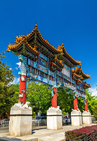 Low angle view of temple against clear blue sky