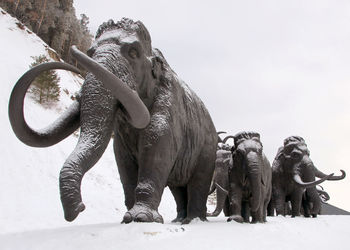 Low angle view of elephant statue against sky