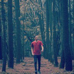 Full length of man standing in forest