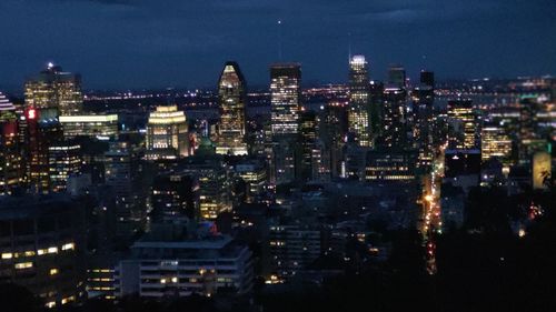 High angle view of illuminated city buildings at night