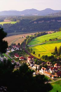 High angle view of houses and agricultural field against sky