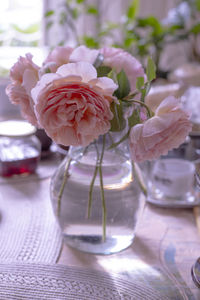 Close-up of rose in glass vase on table