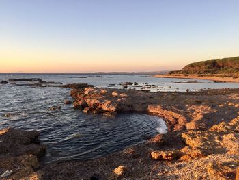 Scenic view of sea against clear sky during sunset