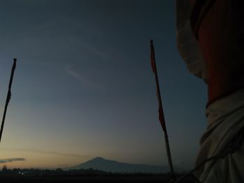 Silhouette person standing on land against sky