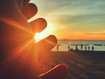 Sun shining over sea during sunset