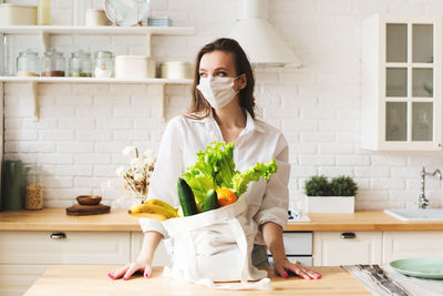 Woman holding food at home