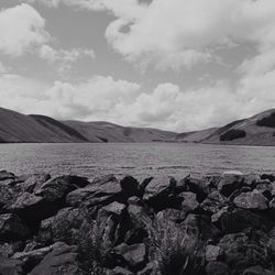 Scenic view of mountains against cloudy sky