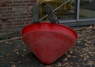 Low section of man working on red cart