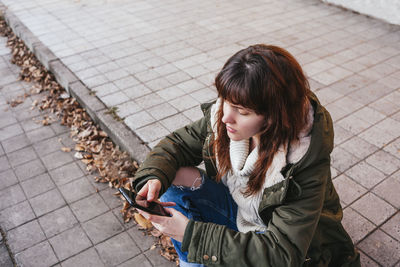 High angle view of woman using mobile phone