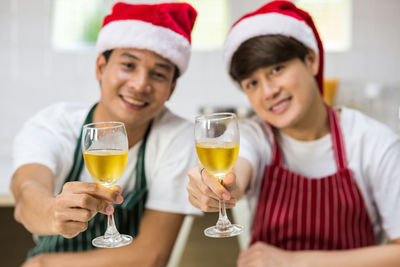 Young man and woman with drink on table