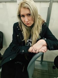 Portrait of young woman sitting on chair