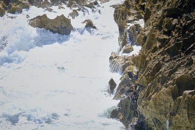Low angle view of frozen mountain against sky