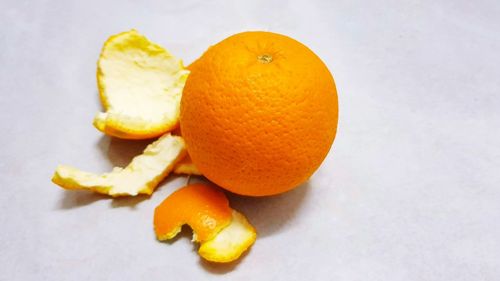 High angle view of orange fruit on white background