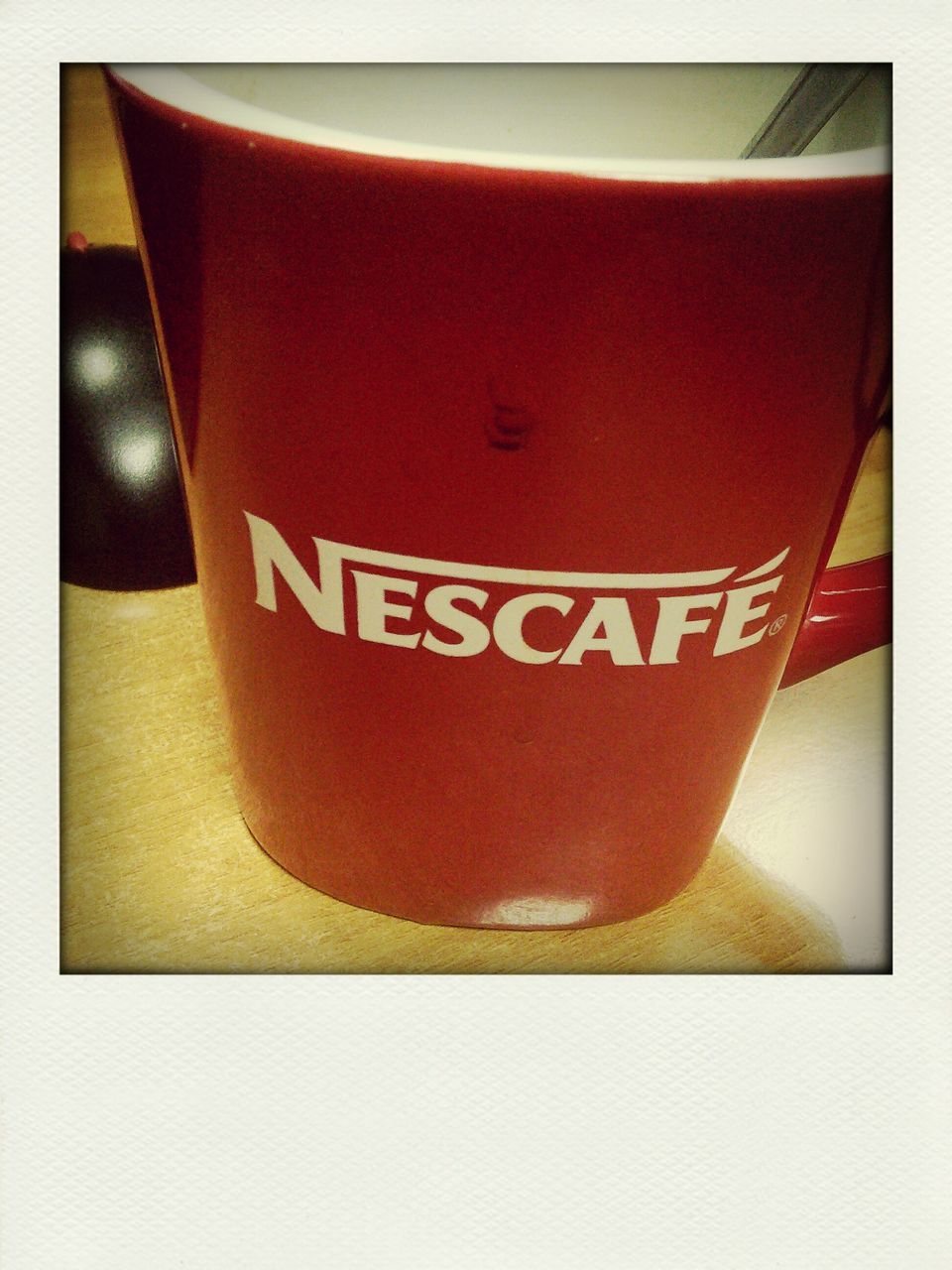 indoors, red, transfer print, text, auto post production filter, table, close-up, still life, western script, communication, drink, no people, high angle view, food and drink, single object, pink color, focus on foreground, coffee cup, refreshment, heart shape