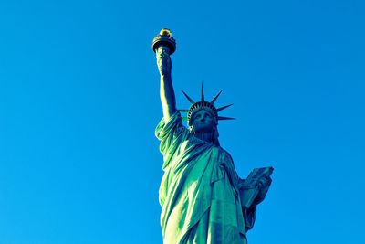 Low angle view of statue against blue sky