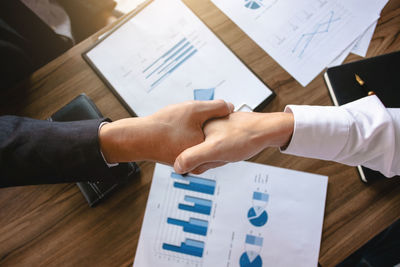 High angle view of hands holding table