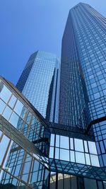 Low angle view of modern glass building against clear sky