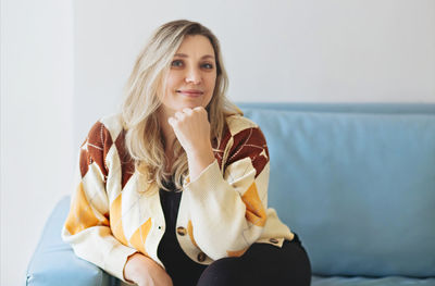 Portrait of woman sitting at home