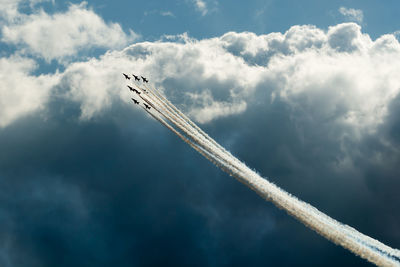 Low angle view of airplane flying against sky