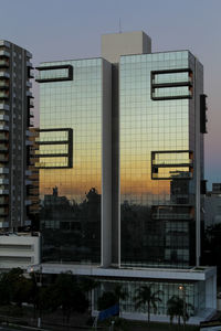 Low angle view of buildings against sky at dusk