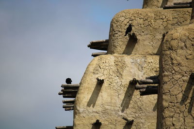 Sculpture of old building against sky
